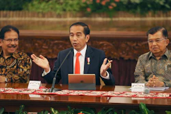 Indonesian President Joko Widodo, center, speaks alongside deputy Jusuf Kalla, right, and Minister of Agrarian and Spatial Planning Sofyan Djalil in Jakarta, Monday, Aug. 26, 2019.