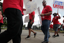 Members of the Communications Workers of America walk a picket line outside of an AT&T office, Monday, Aug. 26, 2019, in Miami.
