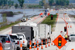 In this May 10, 2019, file photo, vehicles await their turn to cross the single-lane bridge over the Missouri River on Highway 2 near Percival, Iowa.