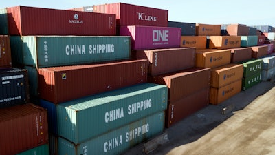 In this May 10, 2019, file photo, China Shipping Company and other containers are stacked at the Virginia International's terminal in Portsmouth, Va.