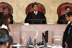South Korean Chief Justice of the Supreme Court Kim Myeong-su, top center, sits with other justices upon their arrival at the Supreme Court in Seoul, Thursday, Aug. 29, 2019.
