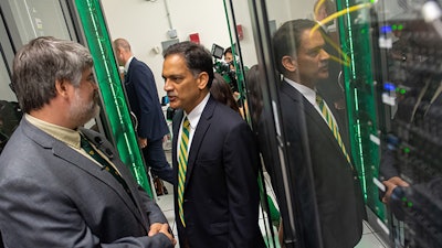 University of Vermont President Suresh Garimella speaks with Mike Austin, director of systems architecture, inside the Vermont Advanced Computing Core, UVM’s supercomputer.