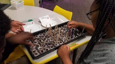 Teens at the Williams Boys & Girls Club of North Alabama conduct a blind experiment that compares the germination rates of tomato seeds that have been to space with control seeds that have never left Earth. Tomatosphere and several other experiments were provided to Boys & Girls Clubs across the country as part of a Space Labs Explorers Challenge from Raytheon and the JFK Library Foundation, in cooperation with the International Space Station National Lab.