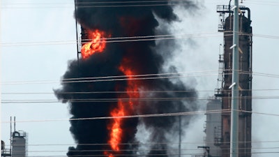 Flames and smoke rise after a fire started at an Exxon Mobil facility, Wednesday, July 31, 2019, in Baytown, Texas.