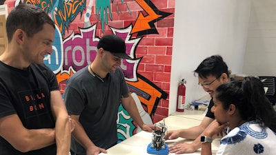 Electrical engineer Alex Starick, production material fabricator Yaniel Ruiz, operations director Chi To So and senior R&D engineer Ash Nanakayya with a Gecko Gripper sub-assembly, Culver City, Calif.