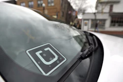 Uber decal in the window of a car.