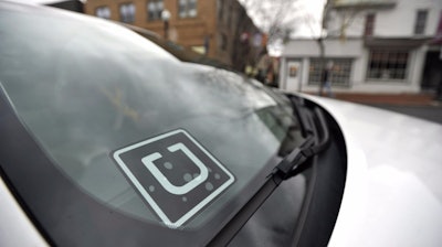 Uber decal in the window of a car.