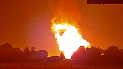 In this Thursday, Aug. 1, 2019 photo provided by Naomi Hayes, a fire burns after an explosion near Junction City, Ky. A regional gas pipeline ruptured early Thursday in Kentucky, causing a massive explosion that killed one person, hospitalized five others, destroyed railroad tracks and forced the evacuation of a nearby mobile home park, authorities said.