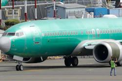 In this May 8, 2019, file photo a worker stands near a Boeing 737 MAX 8 jetliner being built for American Airlines prior to a test flight in Renton, Wash. Boeing is working on new software for the 737 Max that will use a second flight control computer to make the system more reliable, solving a problem that surfaced in June with the grounded jet, two people briefed on the matter said Friday, Aug. 2.