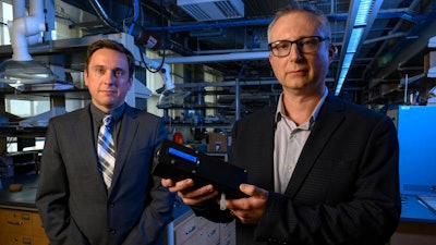 Ervin Sejdic, PhD (left) and Alexander Star, PhD, hold up the prototype of their THC-detecting device.