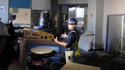 In this Thursday, July 11, 2019, file photo, University of Nevada, Reno Police Chief Todd Renwick describes the damage inside a school dormitory from a July 5 natural gas explosion, in Reno, Nev., during a tour. The University of Nevada, Reno signed a $21.7 million lease agreement Thursday, Aug. 1 to house 1,300 students at a downtown hotel-casino during the coming school year after the natural gas explosion forced the closure of two main residence halls.