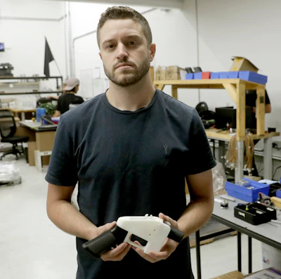 In this Aug. 1, 2018, file photo, Cody Wilson, with Defense Distributed, holds a 3D-printed gun called the Liberator at his shop, in Austin, Texas. On Friday, Aug. 9, 2019, Wilson, who sparked a nationwide legal fight over the constitutionality of firearms made with a 3D printer, pleaded guilty to having sex with an underage girl.