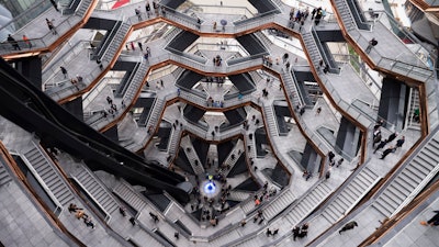 In this March 15, 2019, file photo visitors to 'Vessel' climb its staircases on its opening day at Hudson Yards in New York. The shareholder comes first has for years been the mantra of the Business Roundtable, a group representing the most powerful CEOs in America. The group on Monday, Aug. 19, released a new mission statement that implies a foundational shift; a step back from shareholder primacy.