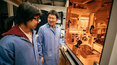 Dartmouth Assistant Professor of Chemistry Chenfeng Ke, right, talks with chemistry graduate student Miao Tang about a 3D printing project Tang designed.