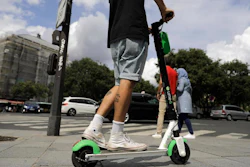 A man rides an electric scooter in Paris, Monday, Aug. 12, 2019.