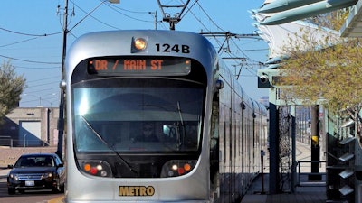 In this Jan. 16, 2016, file photo, a Metro Light Rail train stops for passengers in Phoenix.