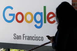 In this May 1, 2019, file photo, a person walks past a Google sign in San Francisco. A federal appeals court has rejected a settlement in a class-action lawsuit alleging that Google spied on users' online activity using tracking 'cookies,' even when privacy settings were set to prevent the snooping. A three-judge panel ruled Tuesday, Aug. 6, that a Delaware judge erred in approving the settlement in 2017.