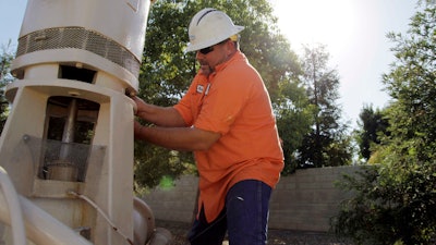 Micha Berry of the city of Fresno, Calif., which relies heavily on groundwater for its drinking water supply, repairs a groundwater well pump in 2013.