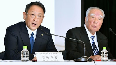 In this Oct. 12, 2016 file photo, Toyota Motor Corp. President Akio Toyoda, left, speaks with Suzuki Motor Corp. Chairman Osamu Suzuki during a news conference in Tokyo. Japan's top automaker, Toyota, and smaller rival Suzuki announced Wednesday, Aug. 28, 2019, they are partnering in the development of self-driving car technology, as manufacturers around the world grapple with innovations in the industry.