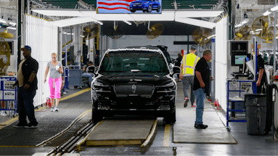 In this June 24, 2019, file photo Ford's employees work on a Lincoln Aviator line at Ford's Chicago Assembly Plant in Chicago's Hegewisch neighborhood. On Thursday, Aug. 15, the Federal Reserve reports on U.S. industrial production for July.