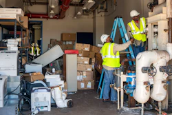 In this July 10, 2019 photo provided by the U.S. Navy, Department of Defense employees Matenis Bell and Andre Ledford, assigned to Naval Air Weapons Station China Lake, Calif., conduct building repairs after multiple earthquakes occurred July 4 and 5 in Kern County, Calif. The base sustained heavy earthquake damage that experts estimate will cost over $5 billion to repair.