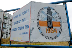This photo taken on Oct. 7, 2018, shows a billboard that reads 'The State Central Navy Testing Range' near residential buildings in the village of Nyonoksa, northwestern Russia. The Aug. 8, 2019, explosion of a rocket engine at the Russian navy's testing range just outside Nyonoksa led to a brief spike in radiation levels and raised new questions about prospective Russian weapons.