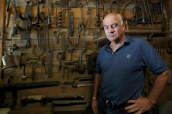 In this Monday, July 22, 2019, photo, Ted Schuster poses for a photo at Prairie Forge in Hopkinton, Iowa. Shuster, now 56, has operated a blacksmithing operation, Prairie Forge, in eastern Iowa for three decades. The small-scale business is a far cry from the big-city environment its owner once considered.