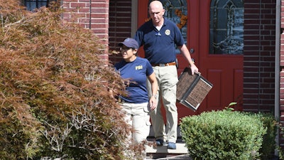 FBI investigators leave the home of UAW President Gary Jones during a search on Wednesday, August 28, 2019 in Canton, Michigan.