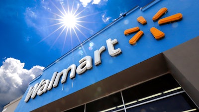 This June 25, 2019, file photo shows the entrance to a Walmart in Pittsburgh. A lawsuit filed earlier this week by Walmart over fires in rooftop solar panels made by Tesla Inc. has been sealed by the court, and both sides say they look forward to addressing all issues. In joint statements Friday, Aug. 23, the companies say they look forward to re-activating the panels once both sides are certain that all concerns have been addressed.