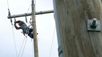 In this Thursday, March 21, 2019, photo, 120 feet off the ground, Jordan Demartino hangs from a training pole near Duke Energy's field office in Simpsonville, S.C.