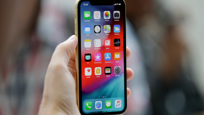 This Sept. 12, 2018, file photo shows an Apple iPhone XR on display at the Steve Jobs Theater in Cupertino, Calif.