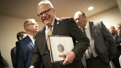 Gov.-elect Tim Walz walking in to a press conference at the State Capitol in St. Paul, Minn., Tuesday, Dec. 18, 2018.
