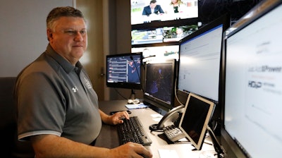 In this July 30, 2019, photo, Paul Hildreth works in the emergency operations center at the Fulton County School District Administration Center in Atlanta.