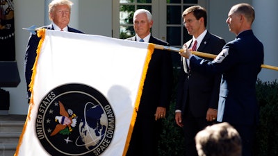 The flag for U.S. Space Command is unfurled during a Rose Garden ceremony, Thursday, Aug. 29, 2019.