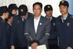 In this Thursday, April 13, 2017, file photo, Lee Jae-yong, center, vice chairman of Samsung Electronics Co., arrives for his trial for bribery and other charges at the Seoul Central District Court.