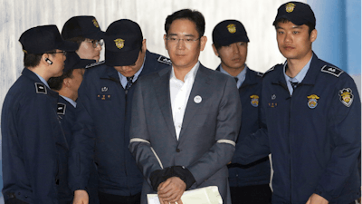 In this Thursday, April 13, 2017, file photo, Lee Jae-yong, center, vice chairman of Samsung Electronics Co., arrives for his trial for bribery and other charges at the Seoul Central District Court.