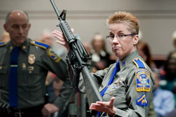 In this Jan. 28, 2013, file photo, Det. Barbara J. Mattson of the Connecticut State Police holds up a Bushmaster AR-15 rifle.