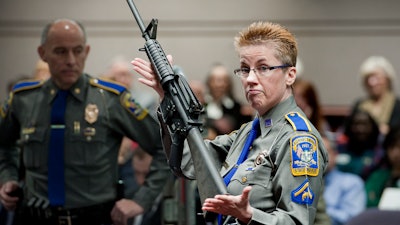 In this Jan. 28, 2013, file photo, Det. Barbara J. Mattson of the Connecticut State Police holds up a Bushmaster AR-15 rifle.
