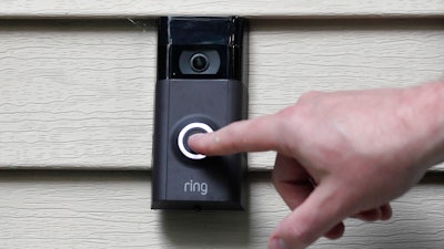 In this Tuesday, July 16, 2019, file photo, Ernie Field pushes the doorbell on his Ring doorbell camera at his home in Wolcott, Conn.