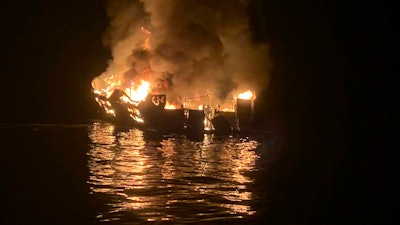 In this Sept. 2, 2019, file photo, a dive boat is engulfed in flames off the Southern California Coast.