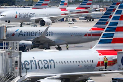 In this April 24, 2019, photo, American Airlines aircraft parked at their gates at Miami International Airport.