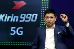 Richard Yu, CEO of the Huawei consumer business group, holds a Kirin 990 5G processor during a keynote at the IFA 2019 tech fair in Berlin, Sept. 6, 2019.