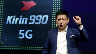 Richard Yu, CEO of the Huawei consumer business group, holds a Kirin 990 5G processor during a keynote at the IFA 2019 tech fair in Berlin, Sept. 6, 2019.