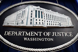In this Thursday, April 18, 2019, file photo, a sign for the Department of Justice hangs in the press briefing room at the Justice Department in Washington.