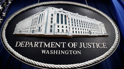 In this Thursday, April 18, 2019, file photo, a sign for the Department of Justice hangs in the press briefing room at the Justice Department in Washington.