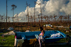 Valentino Ingraham washes clothing amid the rubble of his mother's property destroyed by Hurricane Dorian in Rocky Creek East End, Grand Bahama, Bahamas, Sunday, Sept. 8, 2019.