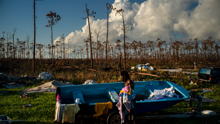 Valentino Ingraham washes clothing amid the rubble of his mother's property destroyed by Hurricane Dorian in Rocky Creek East End, Grand Bahama, Bahamas, Sunday, Sept. 8, 2019.