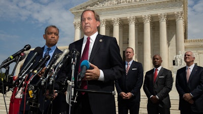 Texas Attorney General Ken Paxton speaks to reporters in front of the U.S. Supreme Court in Washington, Sept. 9, 2019.