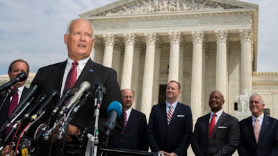Nebraska Attorney General Doug Peterson speaks to reporters in front of the U.S. Supreme Court in Washington, Monday, Sept. 9, 2019.