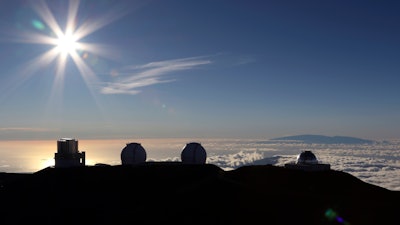 In this July 14, 2019, file photo, the sun sets behind telescopes at the summit of Mauna Kea.